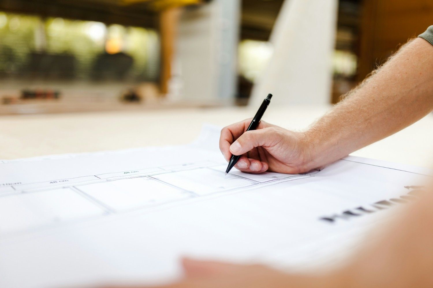 Architectural draft layout specs laid over structured renovation site workspace
